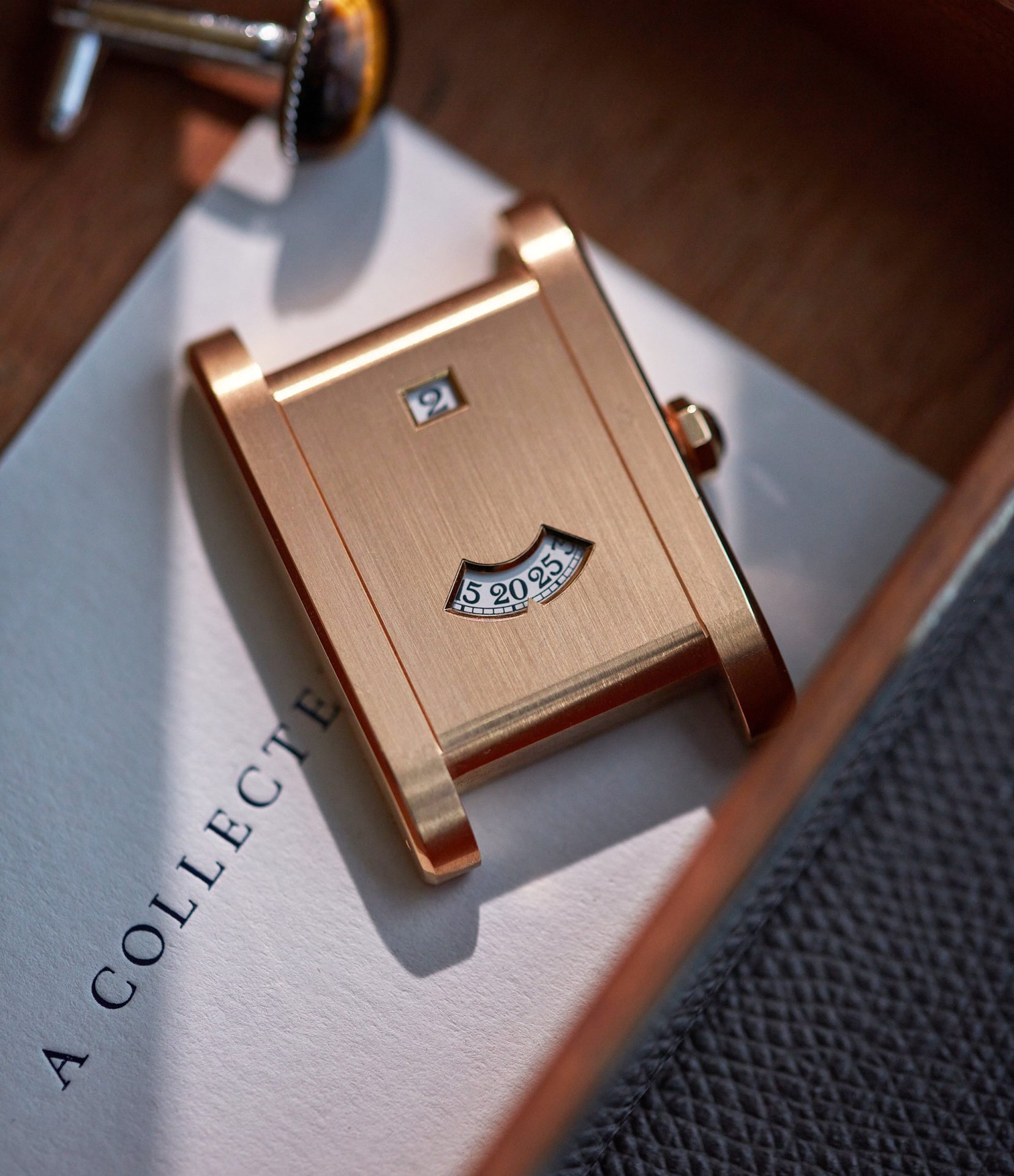 Cartier CPCP Tank à Guichets watch in rose gold on table In A Collector’s Guide to the “Collection Privée Cartier Paris” for A Collected Man London