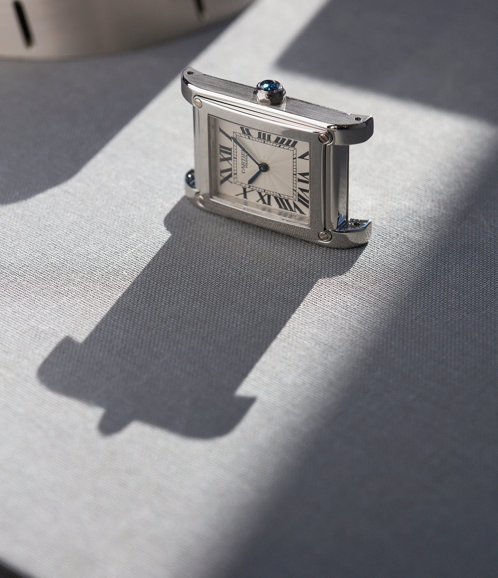 Cartier CPCP Tank à Vis watch on table with long shadow In A Collector’s Guide to the “Collection Privée Cartier Paris” for A Collected Man London
