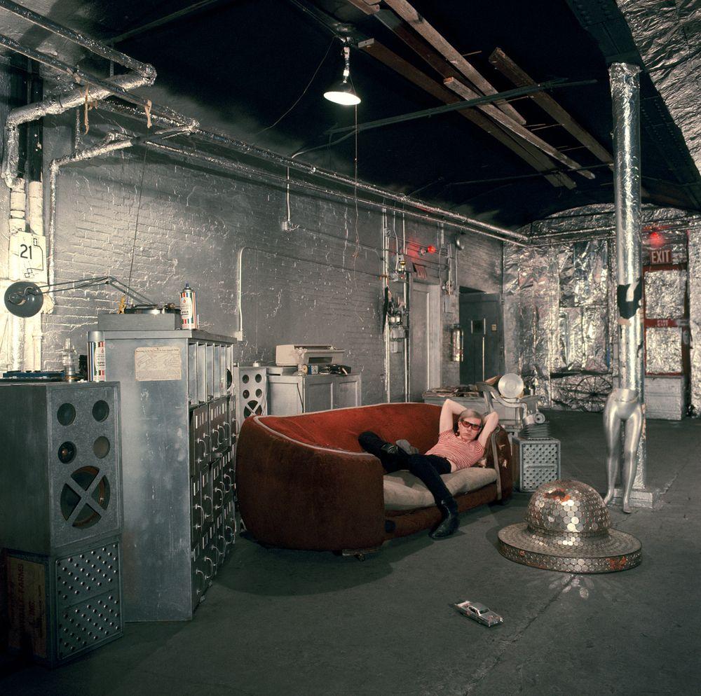 Warhol on the famous red sofa in silverlined room in the Factory in Understanding Andy Warhol as a collector for A Collected Man